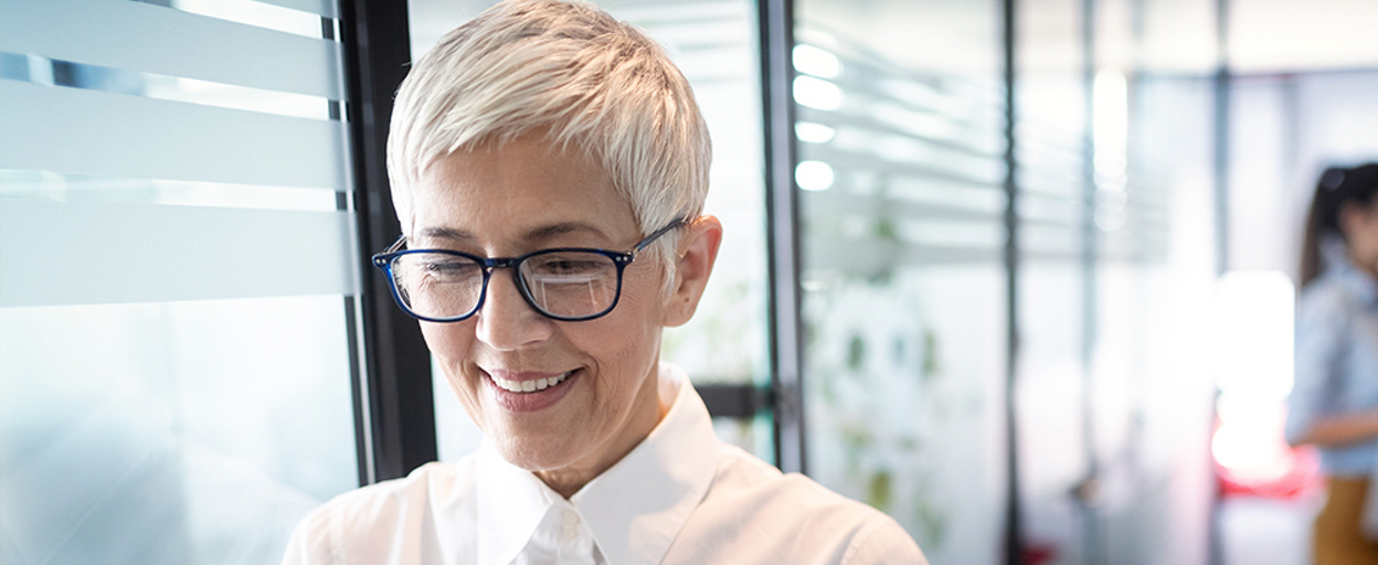 Older woman with short grey hair smiling