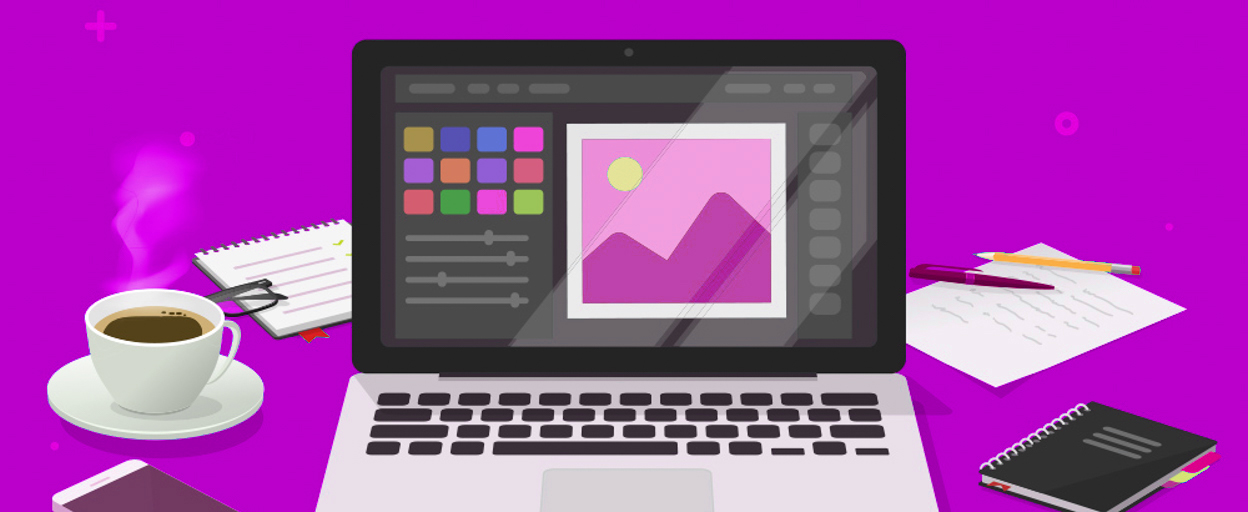 Computer showing graphics with coffee and notebook