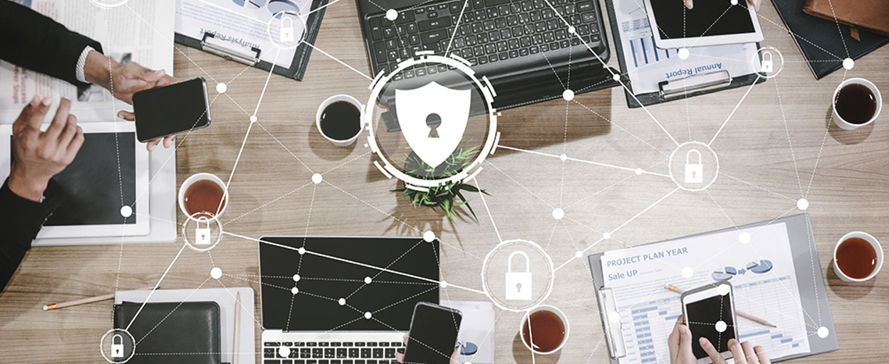 Aerial view of desk with computers with graphic locks laid over top