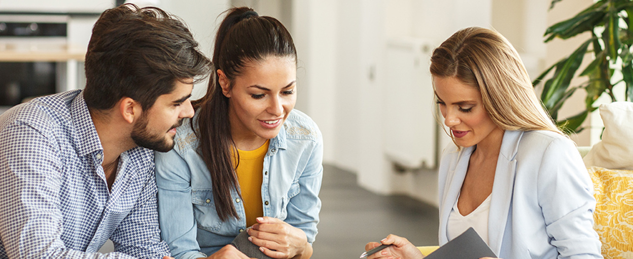 Couple and agent looking at contract 