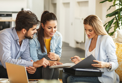 Couple and agent looking at contract 