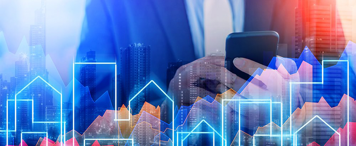 Man typing on phone with city neon lights