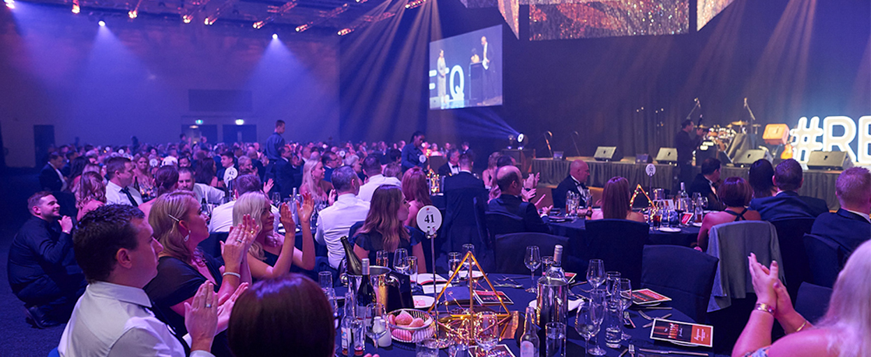 Room of people at tables at Awards event