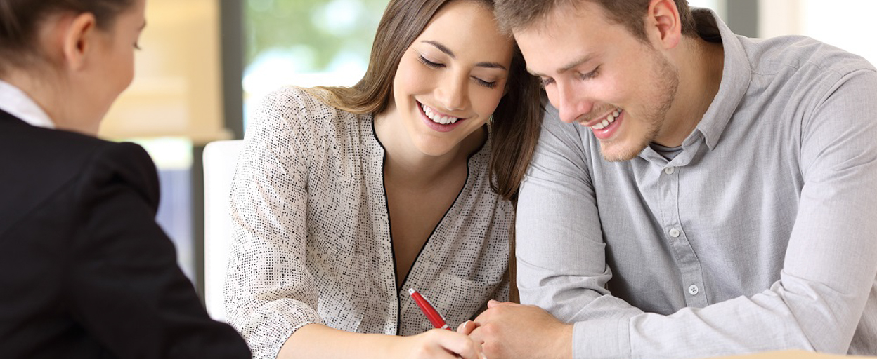 Happy couple signing contract