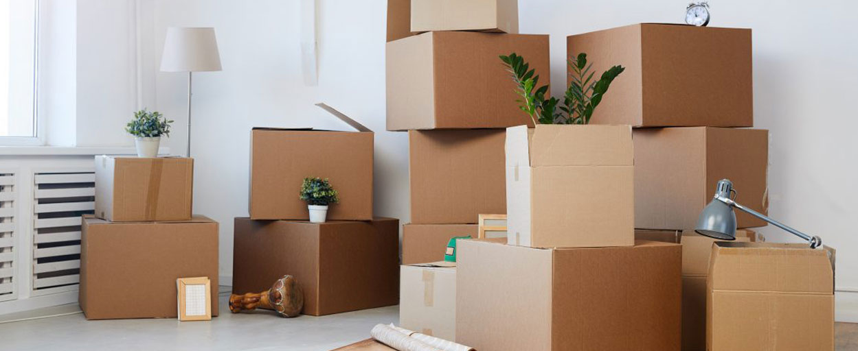Moving out boxes stacked on top of each other filled with household items